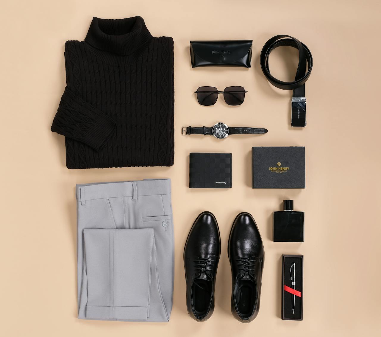 Top view of stylish men's fashion essentials including clothing and accessories arranged on a neutral background.