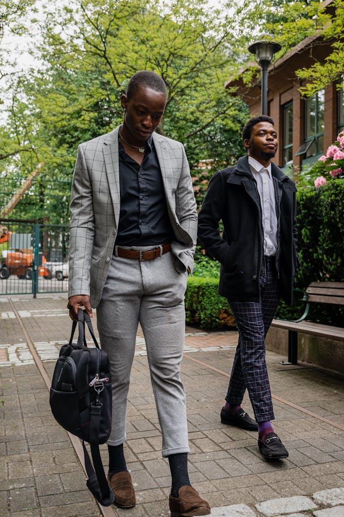 Crafting Captivating Headlines: Your awesome post title goes here Two fashionable men walking confidently in a city park, showcasing modern styles.